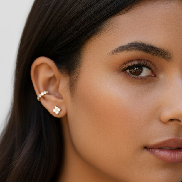 Different model wearing diamond flower earrings and ear cuff