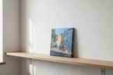 Unframed on wooden shelf
